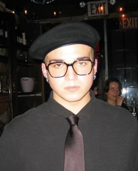 Aleksandr Nuzhnyi in a black beret, glasses and tie